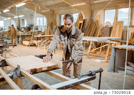 Carpenter working at the carpentry manufacturing 73029018