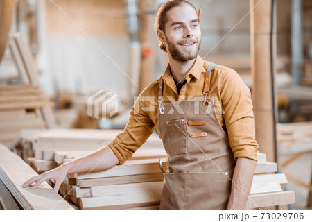 Portrait of a cheerful carpenter 73029706