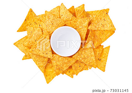 large pile of corn nachos chips and gravy boat isolated on a white background, top view. large pile of corn nachos chips and gravy boat isolated on a white background, top view. 73031145