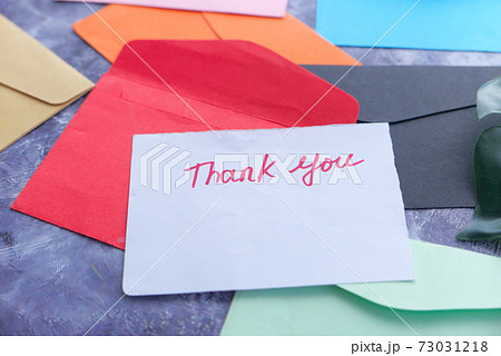 thank you message and envelope on wooden table  73031218