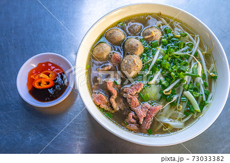 Vietnam flavored Pho bowl- beef meat noodles and vegetables Vietnam flavored Pho bowl- beef meat noodles and vegetables 73033382