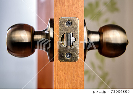 Close-up of new brass door handles with latch. 73034306