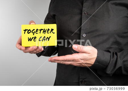 Together We Can. Businessman with a paper card in his hands 73036999