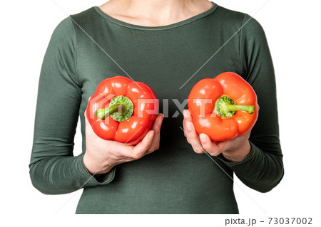 Women's breast health and well-being concept. Red, sweet pepper or paprika Women's breast health and well-being concept. Red, sweet pepper or paprika 73037002