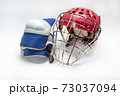 Hockey gloves,helmet and puck lay a white background isolated 73037094