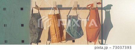 Coronavirus face masks hanging at home closet banner. DIY handmade mask cotton three layers ply. Corona virus prevention facial covering. Panoramic of PPE mask option for corona virus prevention Coronavirus face masks hanging at home closet banner. DIY handmade mask cotton three layers ply. Corona virus prevention facial covering. Panoramic of PPE mask option for corona virus prevention 73037393