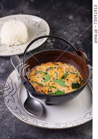 Delicious cream soup with fresh salmon with vegetables and spices. Lunch gourmet 73041913