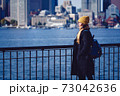 Mid Adult Woman Standing By Cityscape 73042636