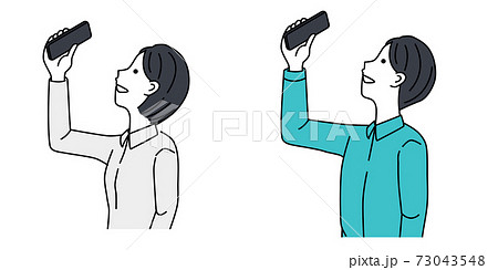 A couple taking pictures with a smartphone A couple taking pictures with a smartphone 73043548