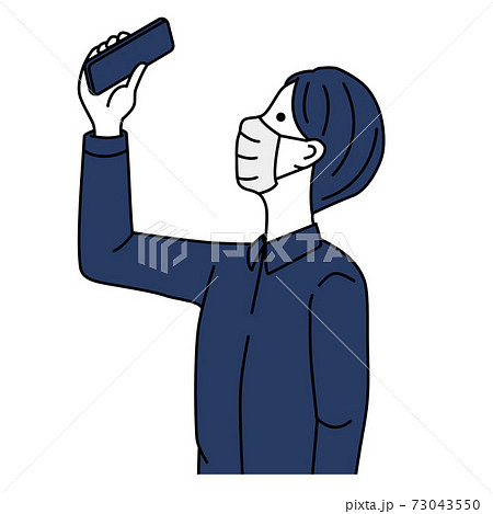 A man in a mask taking pictures with a smartphone 73043550