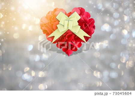Rose petals heart shape with golden gift bow on background bokeh 73045604