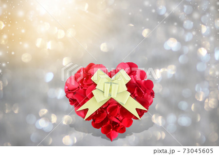 Rose petals heart shape with golden gift bow on background bokeh 73045605