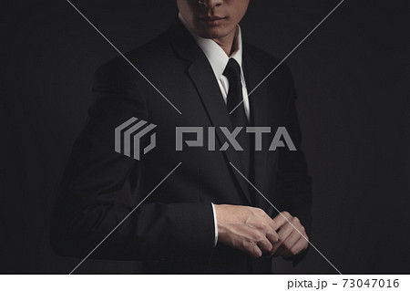 Close up shot of businessman in black suit. Close up shot of businessman in black suit. 73047016