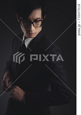 Close up shot of businessman in black suit. Close up shot of businessman in black suit. 73047018
