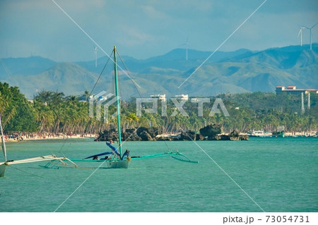 Traditional Filipino boats are anchored near the island of Boracay. The island is without tourists due to the COVID-19 coronavirus pandemic. 73054731