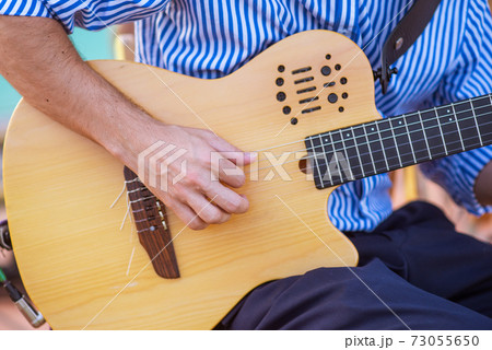 Closeup of a spanish guitar being played 73055650