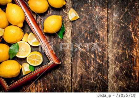 Fresh lemons in the old tray. Fresh lemons in the old tray. 73055719