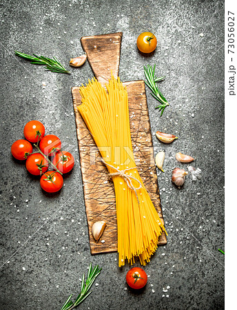 Pasta background. Spaghetti with garlic and tomatoes. Pasta background. Spaghetti with garlic and tomatoes. 73056027