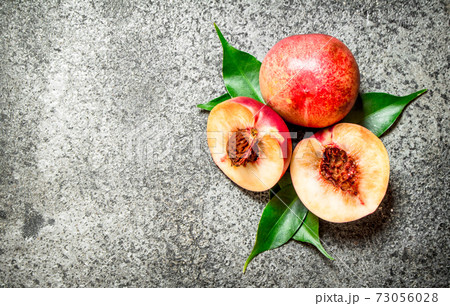 Fresh peaches with green leaves. Fresh peaches with green leaves. 73056028