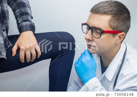 A woman suffers from pain in the inner thigh. The concept of treating a hip joint for trauma, myositis, impaired nerve endingsor osteoarthritis. The doctor examines A woman suffers from pain in the inner thigh. The concept of treating a hip joint for trauma, myositis, impaired nerve endingsor osteoarthritis. The doctor examines 73056148