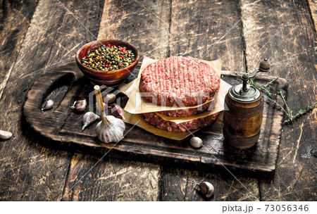 Raw burger with spices and herbs. Raw burger with spices and herbs. 73056346