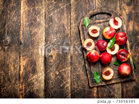 Fresh peaches with green leaves. Fresh peaches with green leaves. 73056395