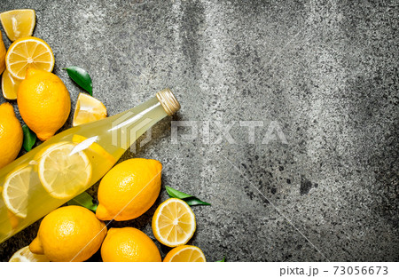 Lemonade in the bottle with slices of fresh lemons. Lemonade in the bottle with slices of fresh lemons. 73056673