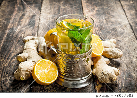 Ginger tea with mint and lemon. Ginger tea with mint and lemon. 73057983