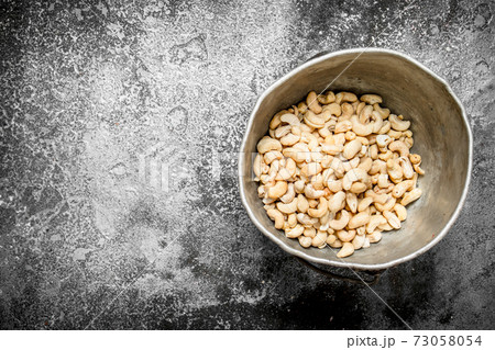 Cashews in the old bucket. Cashews in the old bucket. 73058054