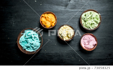 variety of fruit ice cream in a bowl. 73058325