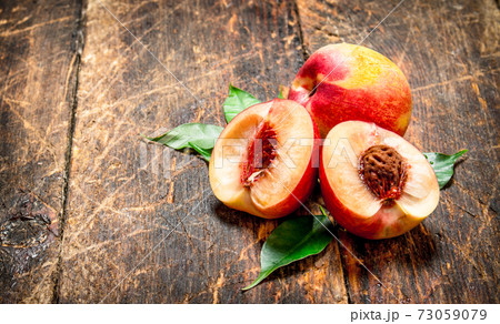 Fresh peaches with green leaves. Fresh peaches with green leaves. 73059079