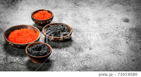 Red and black caviar in wooden bowls. Red and black caviar in wooden bowls. 73059080