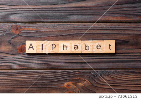 alphabet word written on wood block. alphabet text on cement table for your desing, concept alphabet word written on wood block. alphabet text on cement table for your desing, concept 73061515
