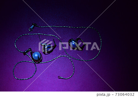 Pendant on a chain and earrings with pearls on a purple table. Pendant on a chain and earrings with pearls on a purple table. 73064032