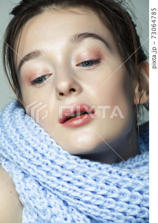 beauty young blond woman in scarf with weathered lips close up, dehydrated winter skin cosmetic concept 73064785
