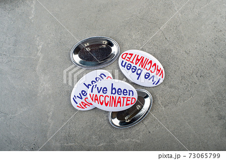 Vaccination campaign button pins on stone tabletop flat lay view 73065799