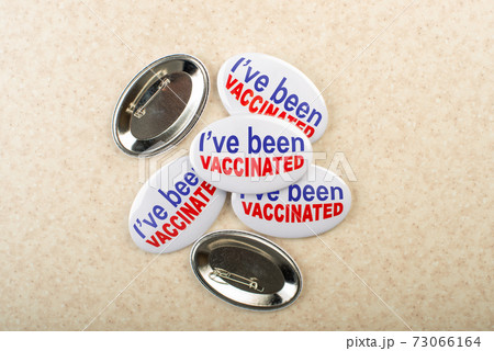 Vaccination campaign button pins on light tabletop flat lay view 73066164