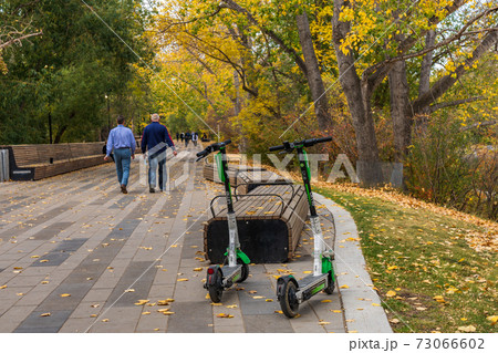 Calgary City electric scooters (e-scooter). Prince's Island Park in Autumn season, AB, Canada Calgary City electric scooters (e-scooter). Prince's Island Park in Autumn season, AB, Canada 73066602