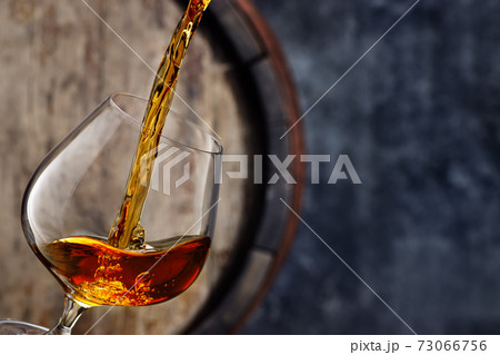 brandy pouring into glass 73066756
