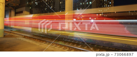 Long exposure photography. Defocused photography of Moscow cityscape in night time. Blurred motion of cable car. Golden and red lights of tram Long exposure photography. Defocused photography of Moscow cityscape in night time. Blurred motion of cable car. Golden and red lights of tram 73066897