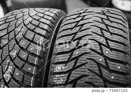 closeup of the tread of two different studded winter tires closeup of the tread of two different studded winter tires 73067105