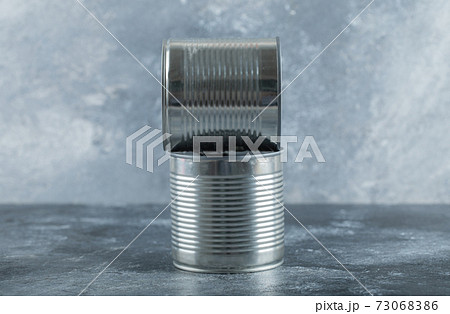 Two metallic cans on a marble background Two metallic cans on a marble background 73068386