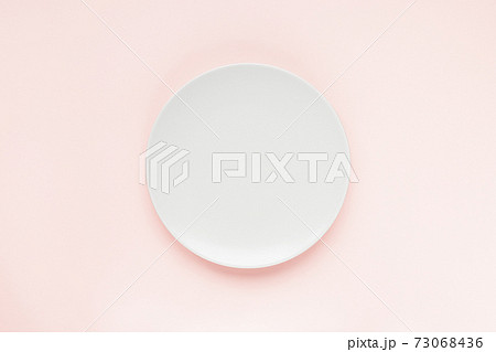 Empty plate on pink background, copy space 73068436