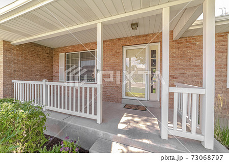 Front porch and door of traditional brick home Front porch and door of traditional brick home 73068797