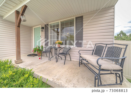 Front porch of modern home with outdoor furniture 73068813