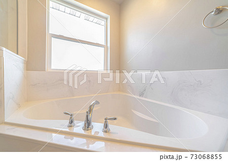 Modern spa bath in new home with bright light 73068855