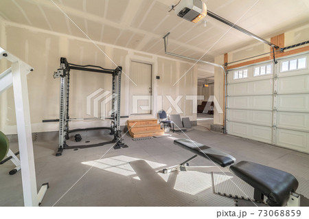 Assorted gym and fitness equipment in a garage Assorted gym and fitness equipment in a garage 73068859