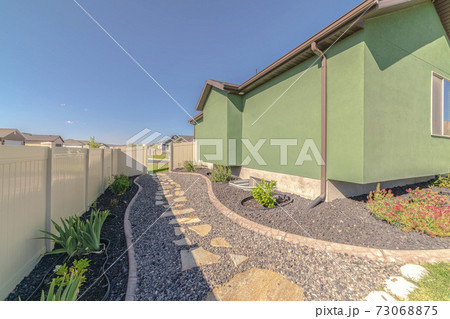 Landscaped garden pathways in suburban backyard day Landscaped garden pathways in suburban backyard day 73068875