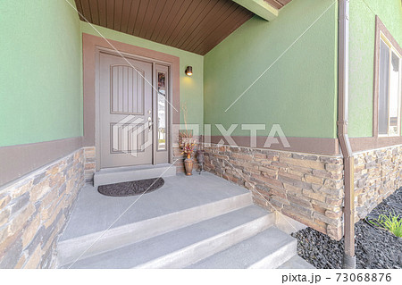 Front porch step and door of traditional home 73068876