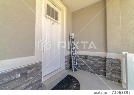 Front door and porch of home with welcome sign Front door and porch of home with welcome sign 73068895